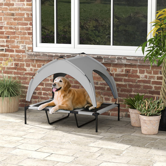 LUXENEST HOME Elevated Dog Bed with Canopy providing shade and comfort for a happy golden retriever outdoors.